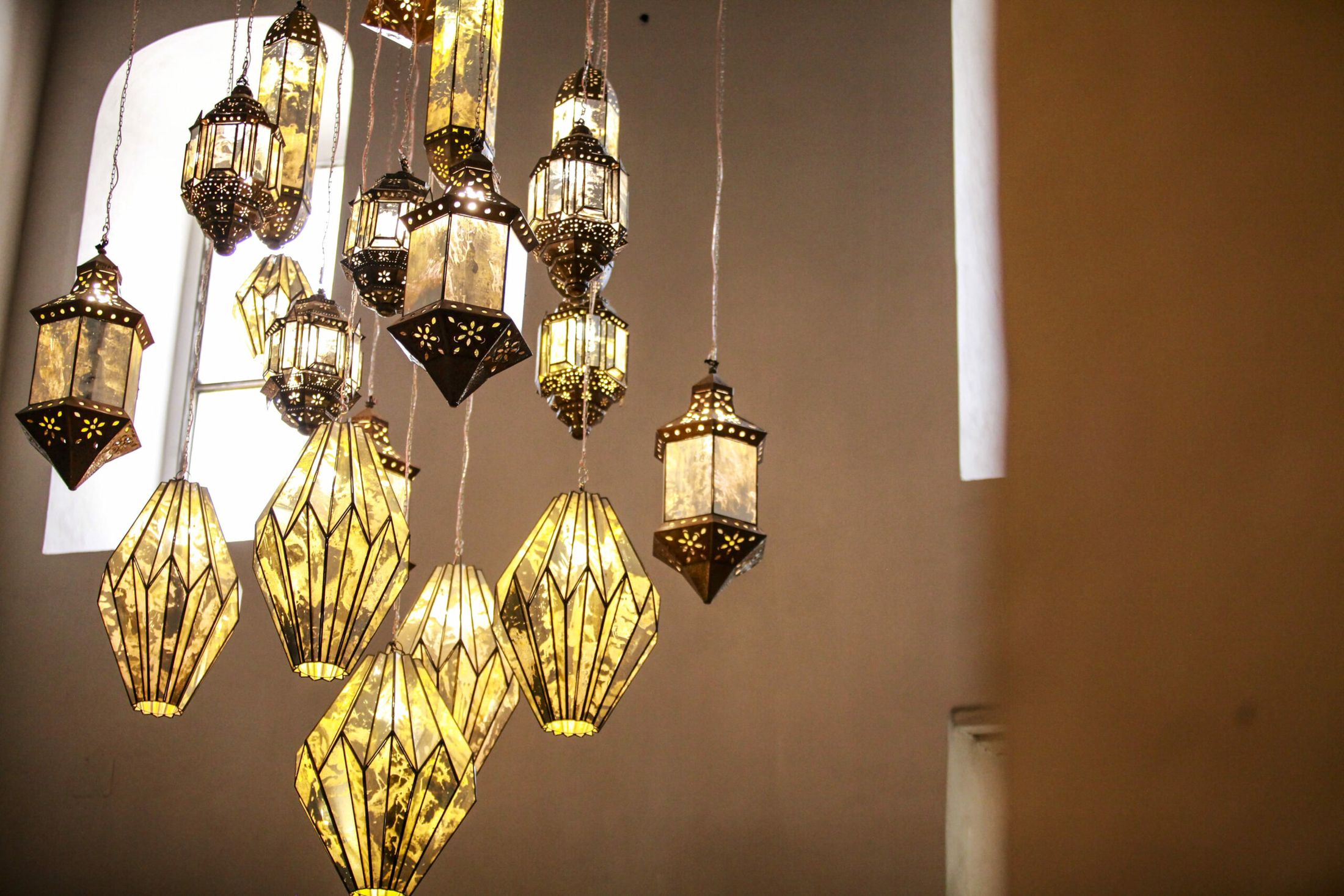 Lámparas artesanales de cristal y latón suspendidas en el Ex Convento